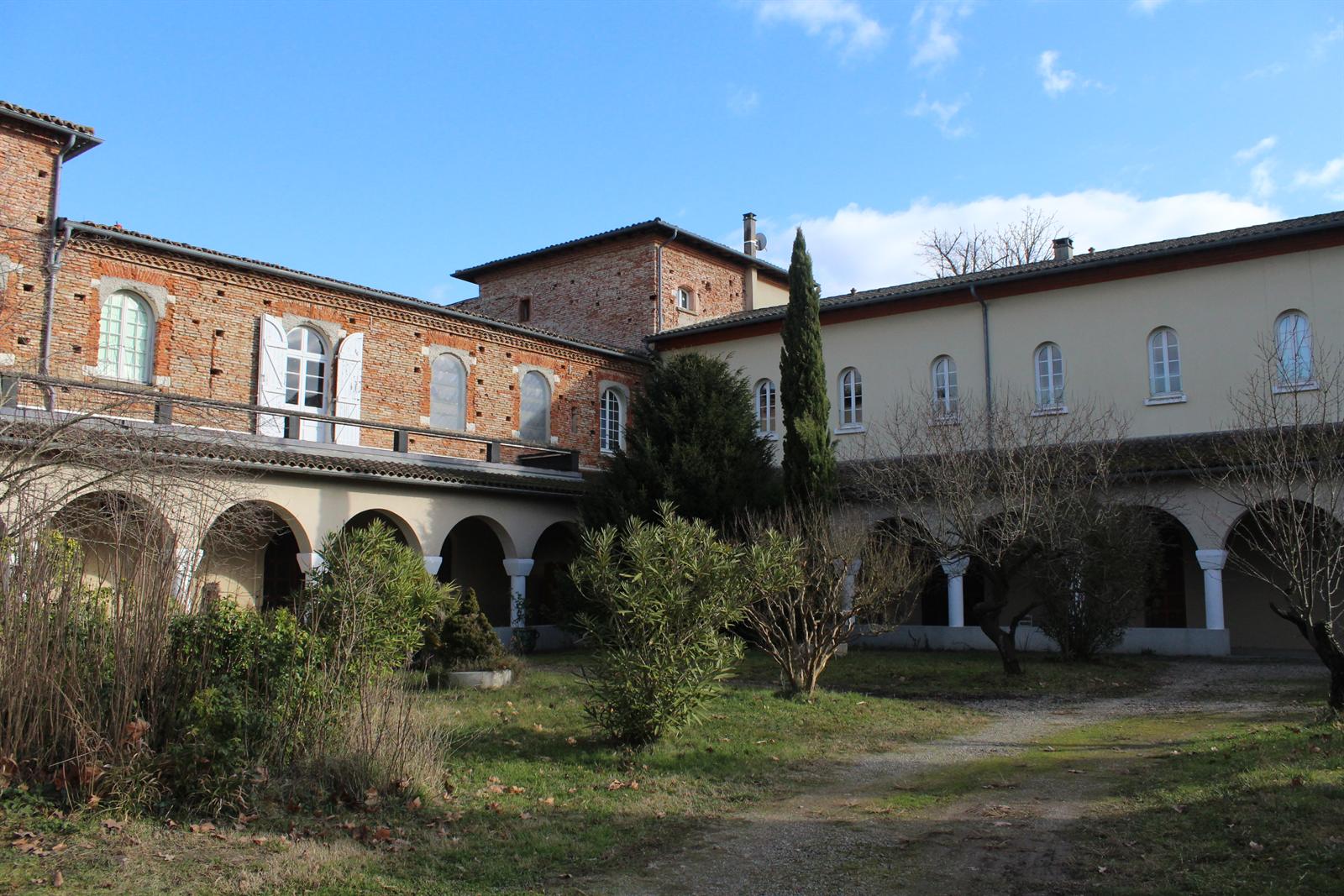 The cloister courtyard with its arcade and the garden enclosed within it.